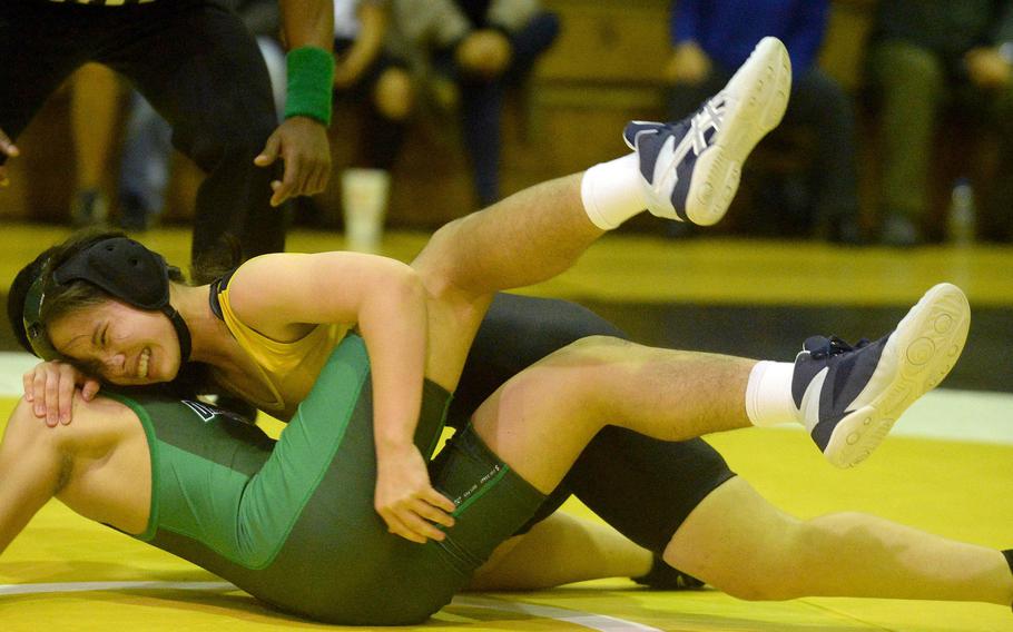 Kadena's Mirai Sato-Marsh grimaces as she tries to finish off Kubasaki's Tristan Fababier at 122 pounds during Wednesday's Okinawa wrestling dual meet. Sato-Marsh pinned Fababier in 1 minute, 33 seconds.