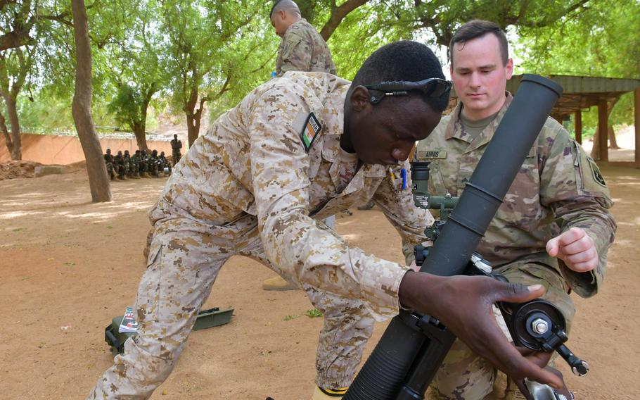 U.S. Cpl. Daniel Annis tests a Nigerien soldier’s skills in Tondibiah, Niger, on May 25, 2021. The U.S., Italy, Morocco and Niger will co-chair the Africa Focus Group within the global coalition battling ISIS. 