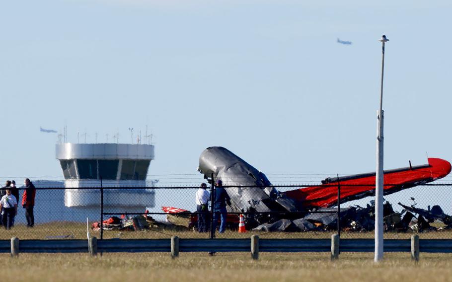 Damage from a mid-air collision between two planes sits within the fence line of the Dallas Executive Airport on Nov. 12, 2022.