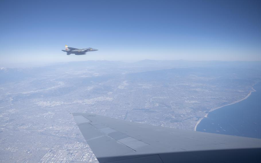 An F-15E Strike Eagle assigned to the 144th Fighter Wing, flies alongside a KC-10 Extender assigned to the 60th Air Mobility Wing, after receiving fuel Feb. 13, 2022, above Los Angeles.