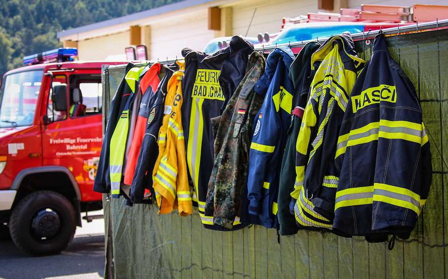 Fire department jackets hang in Bad Schandau, Germany, where military and civilian firefighters battled a wildfire in early August. A fire also broke out at the military training ground in Baumholder, Germany, on Tuesday.