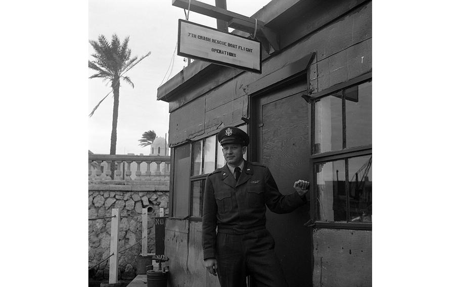 Capt. Richard W. Hughes stands in front of the dockside office of the 7th Crash Rescue Boat Flight. Operating out of Tripoli harbor, Libya, the 7th Flight’s main job is to provide round-the-clock sea rescue coverage for aircraft landing and taking off over the Mediterranean from Wheelus Field, five miles down the coast.