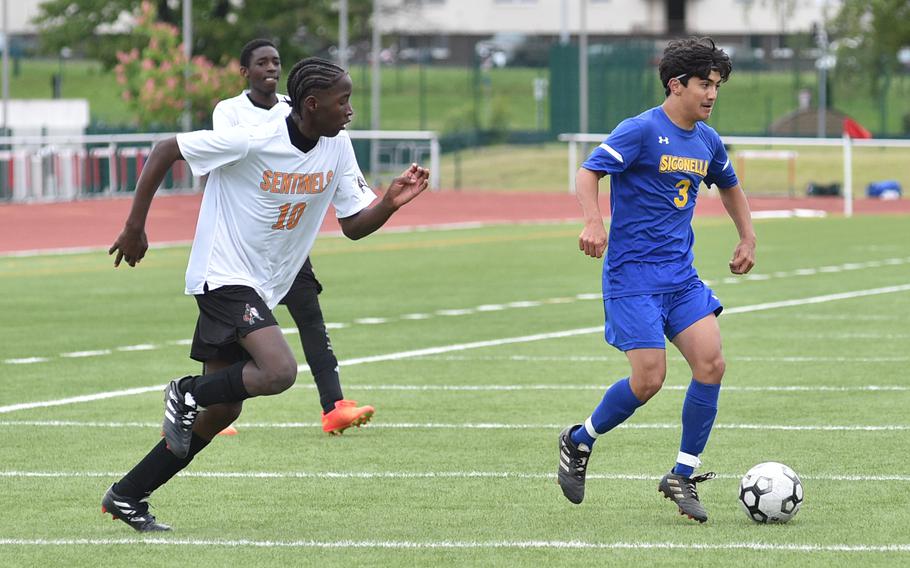 Sigonella senior Alessandro Montero looks at his options while Spangdahlem's Darrian Kelly defends during pool play of the Division III DODEA European championship on May 16, 2023, at Kaiserslautern High School in Kaiserslautern, Germany.