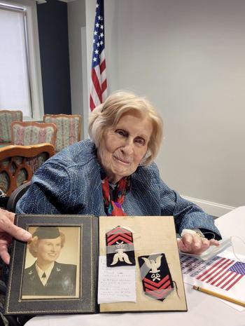 Barnes with her official Navy photo and arm patches on Veterans Day at the Virginian assisted-living center last year.