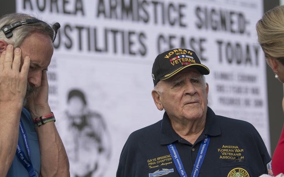 Gate Briseno, who served in the Oklahoma National Guard's 45th Infantry Division during the Korean War, chats with Sharlene Wells, right, before a ceremony just outside the Korean War Memorial on the National Mall in Washington, D.C. where the memorial's new Wall of Remembrance was dedicated on Wednesday, July 27, 2022.  Briseno said while he served in Korea, he always felt like he was not going to make it home that “death was tugging at your elbow.” To cope, he said he mostly avoided making good friends, “because it hurts too much when you lose them.” On the remembrance wall, Briseno found the names of two he did befriend. “Murph… He died in my arms. The only friend I really made. Him and Swan. I felt them with my hands. They were there.”