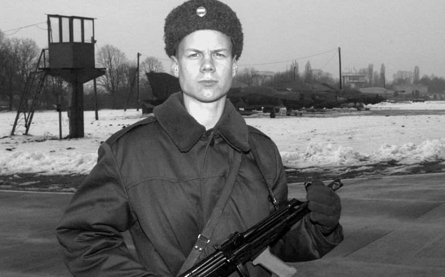 Taszar AB, Hungary, January, 1996: A young Hungarian airman stands guard at Taszar's airstrip, not at all happy that his superiors treat the American forces on his base better than there own people.