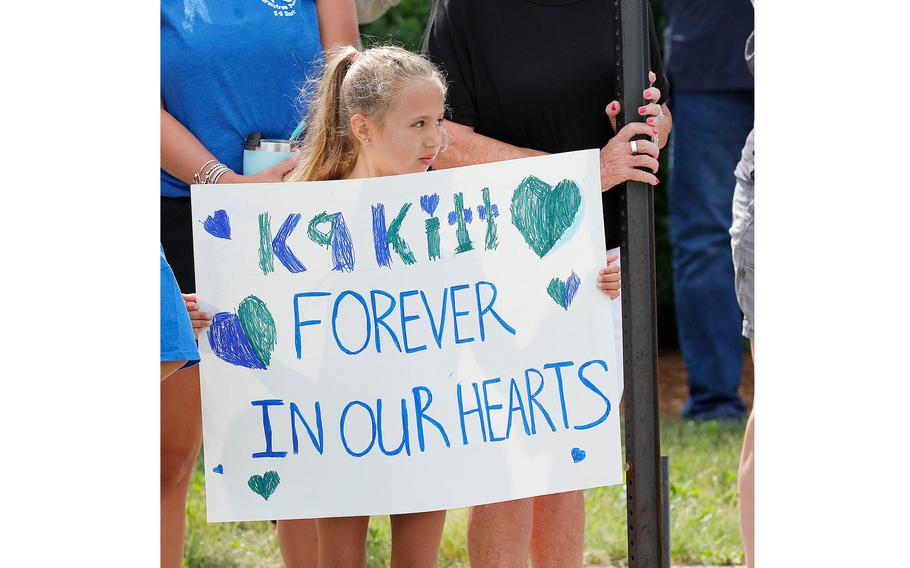 Brooke Wheaton, 6, made a sign to remember police dog Kitt at a funeral on June 22, 2021.