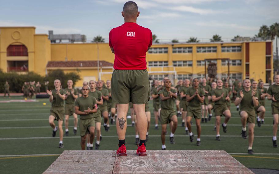 A U.S. Marine Corps Chief Drill Instructor with Charlie Company, 1st Recruit Training Battalion, leads warm-ups at Marine Corps Recruit Depot, San Diego, Nov. 23, 2021. 