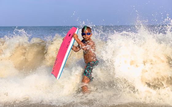 Zephyr Martell enjoys the surf at Assateague Beach in Virginia in August 2020. MUST CREDIT: Photo for The Washington Post by Nevin Martell