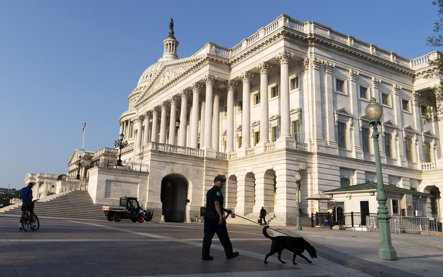 The U.S. Capitol is seen in Washington, early Tuesday, July 27, 2021, as U.S. Capitol Police watch the perimeter. Democrats are launching their investigation into the Jan. 6 Capitol insurrection. They’re beginning with a focus on the law enforcement officers who were attacked and beaten as the rioters broke into the building. It’s an effort to put a human face on the violence of the day. The police officers who are testifying Tuesday endured some of the worst of the brutality. The panel’s first hearing comes as partisan tensions have only worsened since the insurrection. Many Republicans have played down or outright denied the violence that occurred and denounced the Democratic-led investigation as politically motivated. 