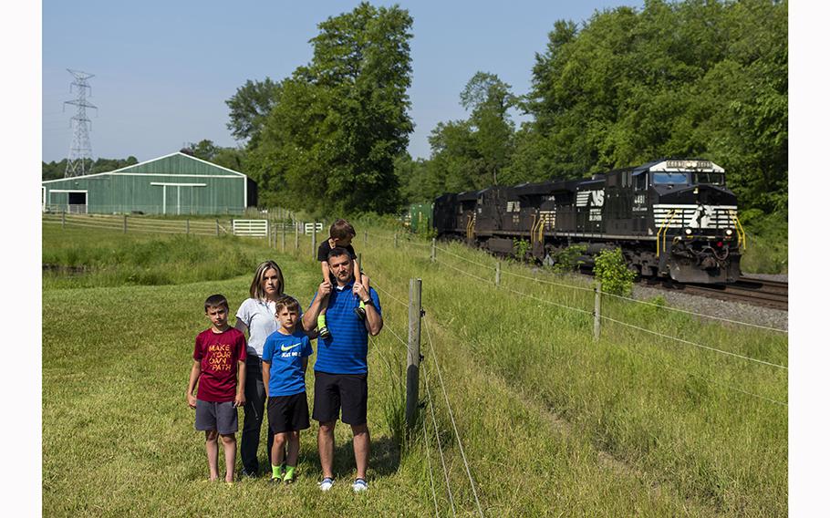 Jessica Conard, her husband Chad Conard, and their children, Noah, Jagger, and Rhys, outside their home in East Palestine. The Conards are skeptical that it is safe in East Palestine following a toxic train derailment. 