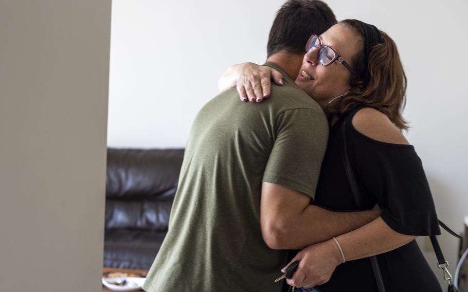 Kim Staffieri, co-founder of the Association of Wartime Allies, hugs an Afghan refugee, a former U.S. interpreter, while visiting him at his new apartment in Rochester, N.Y. on June 13, 2022. 