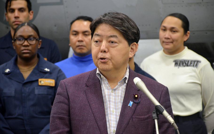 Japanese Foreign Minister Yoshimasa Hayashi speaks with reporters aboard the aircraft carrier USS Abraham Lincoln in the Philippine Sea, Saturday, April 23, 2022. 