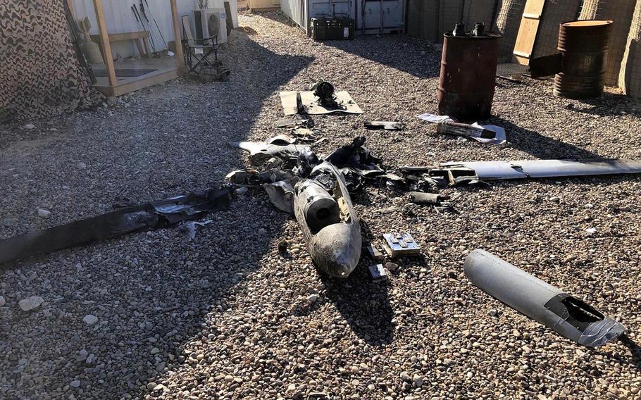 Parts of the wreckage of a drone are laid out on the ground near the Ain al-Asad airbase, in the western Anbar province of Iraq, Tuesday, Jan. 4, 2022. 