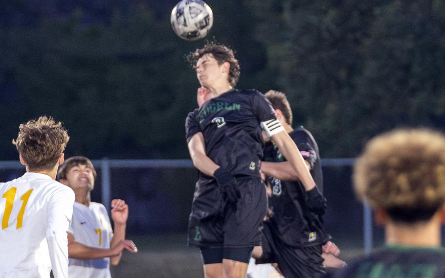 Santiago Castano heads the ball.