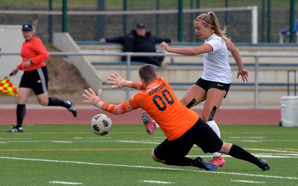 Ramstein keeper Bailey Bennett comes out to try to stop a shot by Stuttgart’s Meredith Fleming in the Division I girls final at the DODEA-Europe soccer championships in Ramstein, Germany, May 22, 2025. Ramstein beat Stuttgart for the title 3-1.