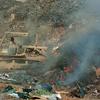 Sgt. Richard Ganske, a soldier with the 84th Combat Engineer Battalion, uses a bulldozer to push refuse into a burn pit in Balad, Iraq, on Sept. 24, 2004. Inclusion on the Department of Veterans Affairs burn pit registry is now automatic for certain deployment locations, including Iraq.