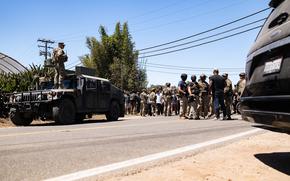 Soldiers assigned to 870th Military Police Company, 185th Military Police Battalion, 49th Military Police Brigade, California National Guard, serving under Title 10 status, provide a security perimeter for federal personnel conducting law enforcement activities at Carpinteria, Calif., July 10, 2025. U.S. Northern Command is supporting federal agencies by providing military forces to protect federal functions, personnel, and property in the greater Los Angeles area. On June 7, the Secretary of Defense directed USNORTHCOM to establish Task Force 51 to oversee Title 10 forces supporting this mission. (U.S. Army photo by Sgt. Chase Murray)