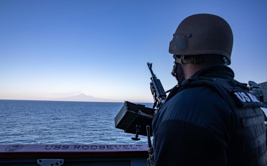 Petty Officer 2nd Class Edem Asamoah-Wade mans a M-240B machine gun aboard the destroyer USS Roosevelt, Feb. 11, 2022, in Augusta Bay off the coast of Sicily. 