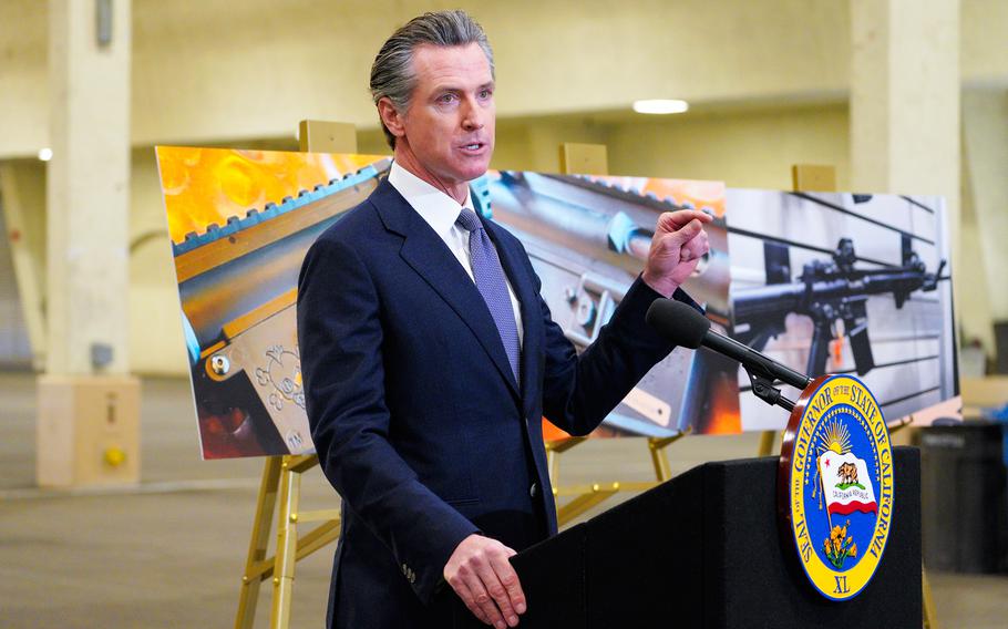 California Gov. Gavin Newsom, along with several elected officials, meets with the media at Del Mar Fairgrounds on Friday, Feb. 18, 2022, in Del Mar, Calif., where he backed state legislation that would allow for private citizens to enforce the state's ban on assault weapons.