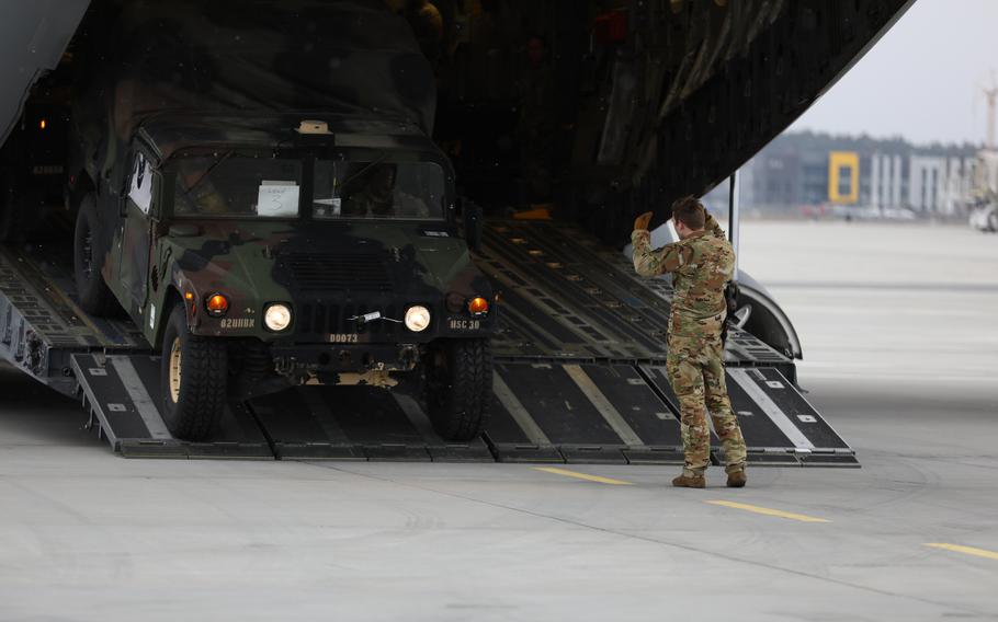 An airman from the U.S. Air Forces 435th Air Ground Operations Wing directs personnel from the 82nd Airborne Division as they unload their equipment at Rzeszow-Jasionka Airport, Poland, Feb. 6, 2022. Service members won't be expected to evacuate Americans from Ukraine if Russia launches a new invasion, said President Joe Biden, who added that U.S. citizens should leave Ukraine immediately. 