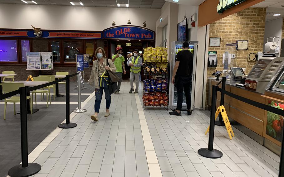 Patrons and workers walk through the food court at Naval Support Activity Naples on Oct. 21, 2021. Three U.S. military bases in Italy, including Naples, completed screening of all local national workers last week to comply with an Italian law requiring all workers have a coronavirus health pass.