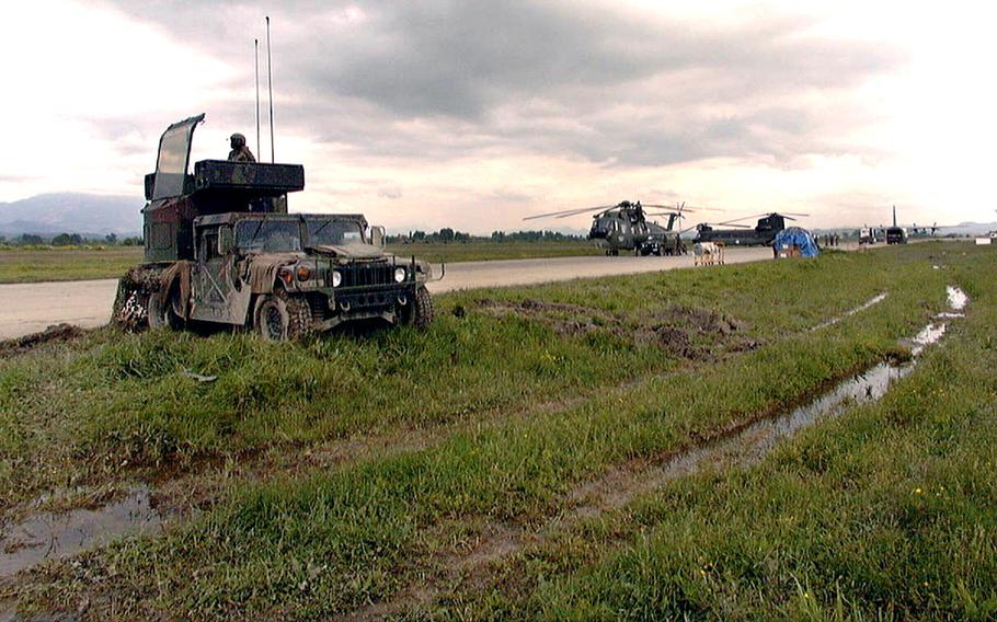 A U.S. Army soldier sits atop an Avenger, Air Defense Artillery Unit, covered in the ubiquitous mud, parked at Rinas Airport, Tirana, Albania, April 27, 1999.