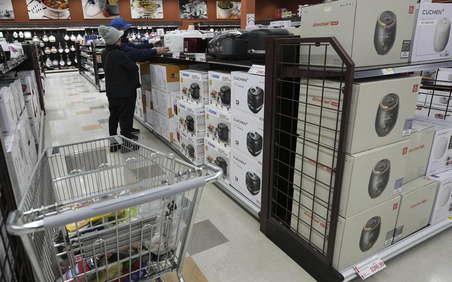 Shoppers examine the merchandise.