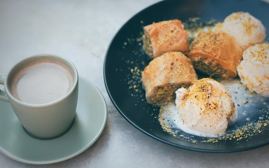 Kurdish coffee pairs well with a plate of baklava and fresh vanilla ice cream at Civat Middle Eastern Kitchen in Landstuhl, Germany, Aug. 7, 2022. Kurdish coffee is not made from coffee beans, but with roasted and ground tarabinth. 