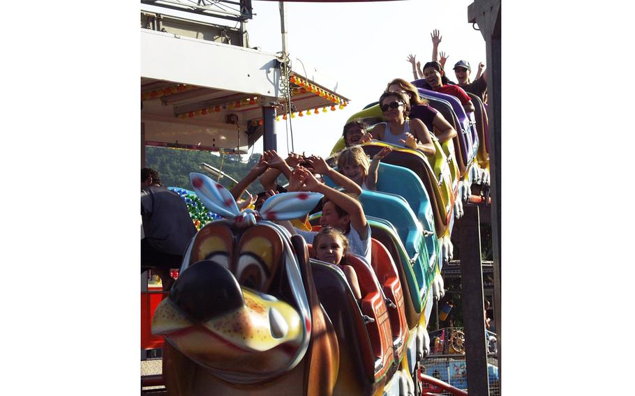 People ride a rollercoaster