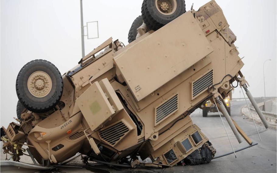 A Mine-Resistant Ambush-Protected vehicle rests on its turret and hood after a rollover. Soldiers can avoid tactical vehicle accidents by engaging and reinforcing drivers' skills training by conducting rollover drills, making sure all crew members use restraints, ensuring that tire pressure is correct on their vehicles, employing composite risk management, and briefing road conditions before each mission.