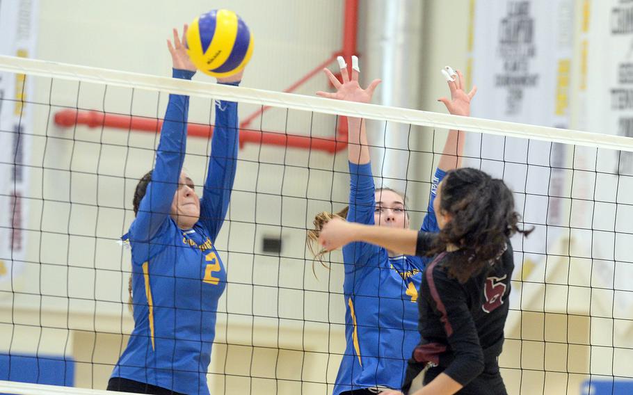 Matthew C. Perry's Haleigh Quinn has her shot blocked by Yokota's Malia Hutchins during Saturday's DODEA-Japan volleyball match. The Panthers won in four sets.