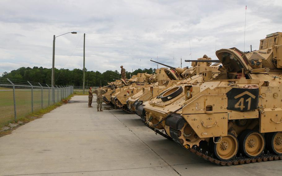 Soldiers assigned to the 6th Squadron, 8th Cavalry Regiment, 2nd Armored Brigade Combat Team of the 3rd Infantry Division conduct preventative maintenance and checks on their Bradley Fighting Vehicles at Fort Stewart, Ga., in 2021. 