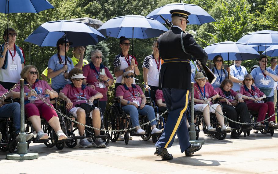 Female veterans watch as a soldier walks by