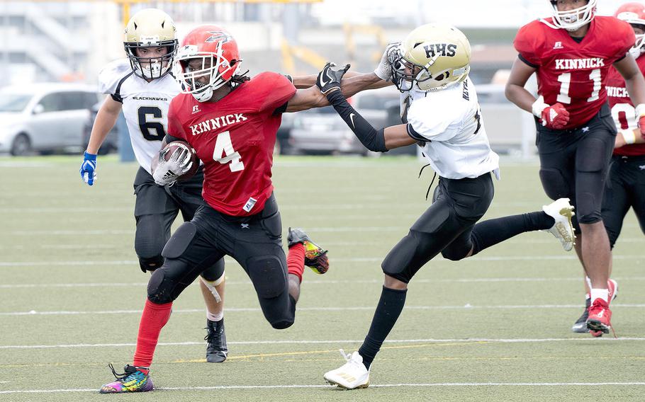 Nile C. Kinnick's Tre Bennett eludes two Humphreys defenders. He rushed for 98 yards and a touchdown on 14 carries.