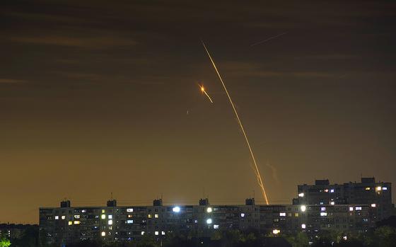 Russian rockets launch against Ukraine from Russia's Belgorod region are seen at dawn in Kharkiv, Ukraine, early Sunday, May 14, 2023. (AP Photo/Vadim Belikov)