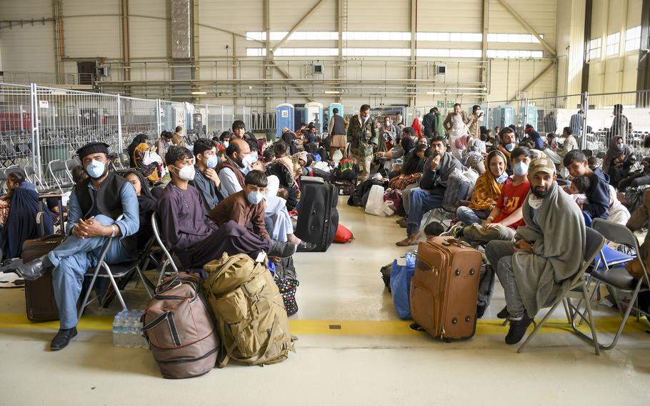 Afghan evacuees wait for flights to the U.S. in a hangar at Ramstein Air Base in Germany on Wednesday, Sept. 1, 2021. 