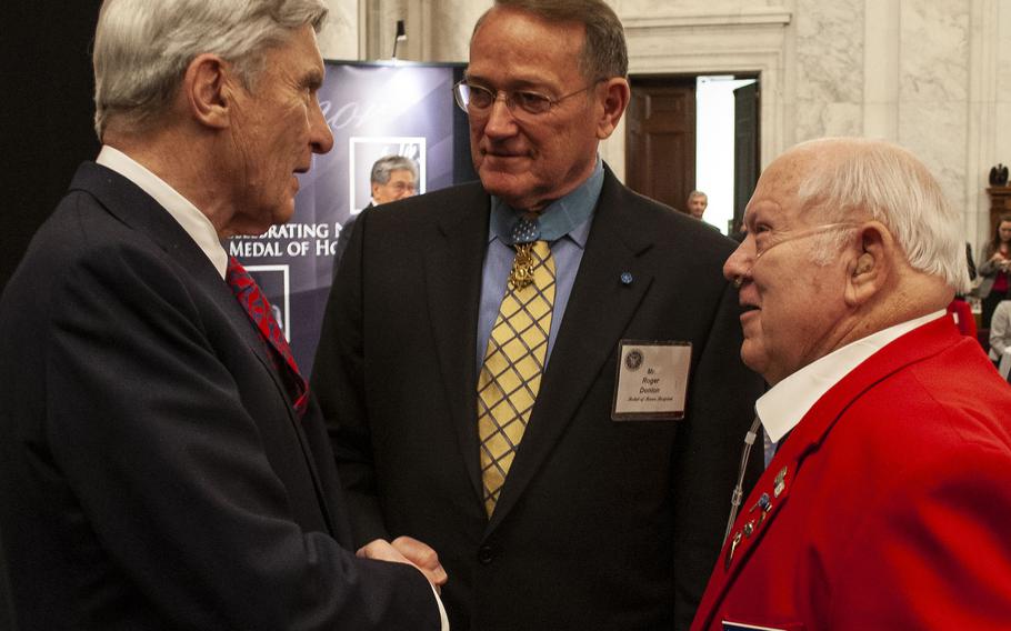 Former Sen. John Warner, left, talks with Medal of Honor recipients Roger Donlon, center, and Jack Lucas during a reception in Washington, D.C. in 2007.