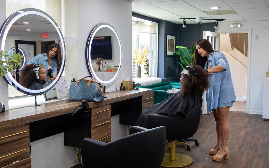 Tuba Sim works on Joanne Robinson's hair at Salon Simis in Fairfax, Va., on June 16, 2022. 