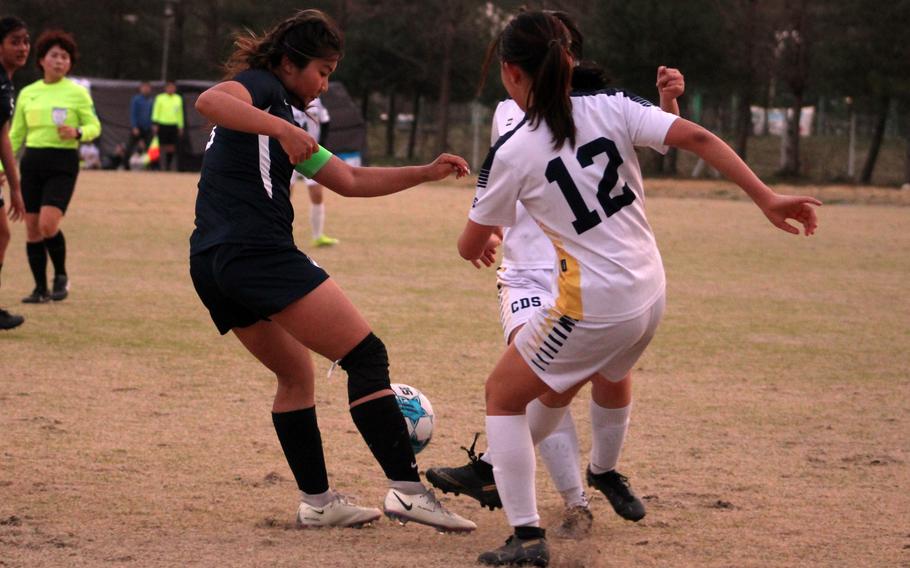 Osan's Clarice Lee battles for the ball against Cheongna Dalton during Wednesday's Korea girls soccer match. The teams played to a 0-0 draw.