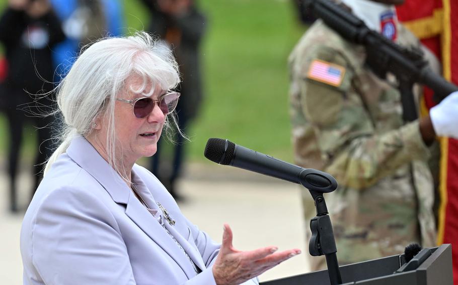 A woman speaks at a podium.