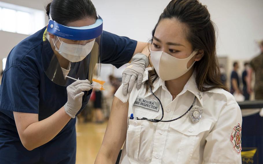 Fire inspector Kaede Miura receives her first dose of the Moderna COVID-19 vaccine at Yokosuka Naval Base, Japan, Friday, June 18, 2021. 