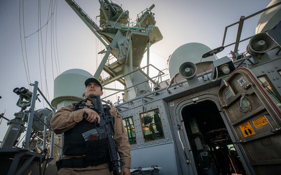 Lt. j.g. Andres Andrade stands watch aboard the Arleigh Burke-class guided-missile destroyer USS Carney during a transit of the Suez Canal, Nov. 6, 2023. The USS Carney shot down drones and a missile launched by Yemen’s Houthi rebels toward it in the Red Sea, officials said.