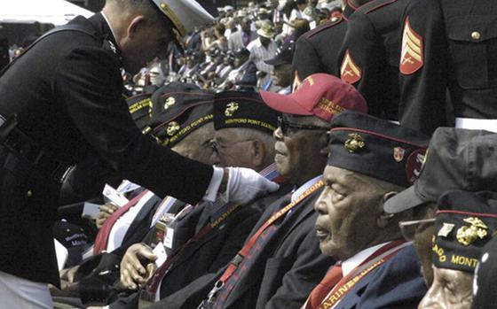 Hundreds of Montford Point Marines are presented with a bronze replica of the Congressional Gold Medal during a ceremony at the Marine Barracks in Washington, D.C., on June 28, 2012. Atlanta resident Lee Raymond Shelton was one of the latest Montford Marines to get his recognition on Wednesday, Feb. 8, 2023.