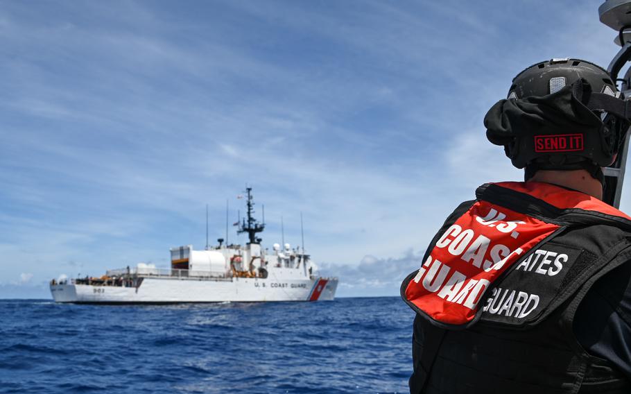 Boarding team members in a small boat prepare to pull alongside the U.S. Coast Guard Cutter Harriet Lane for a passenger transfer in the Pacific Ocean on Feb. 6, 2024. 