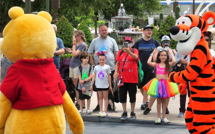 Guests watch Winnie the Pooh and Tigger at the Magic Kingdom in May 2021. 
