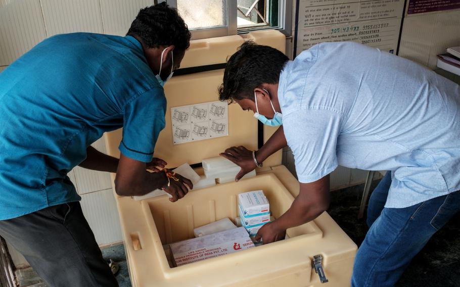 Hospital workers check supplies of the Covid-19 vaccine manufactured by Serum Institute of India, at the Simdega Sadar Hospital in Simdega, Jharkhand, India, on Aug. 23, 2021. 