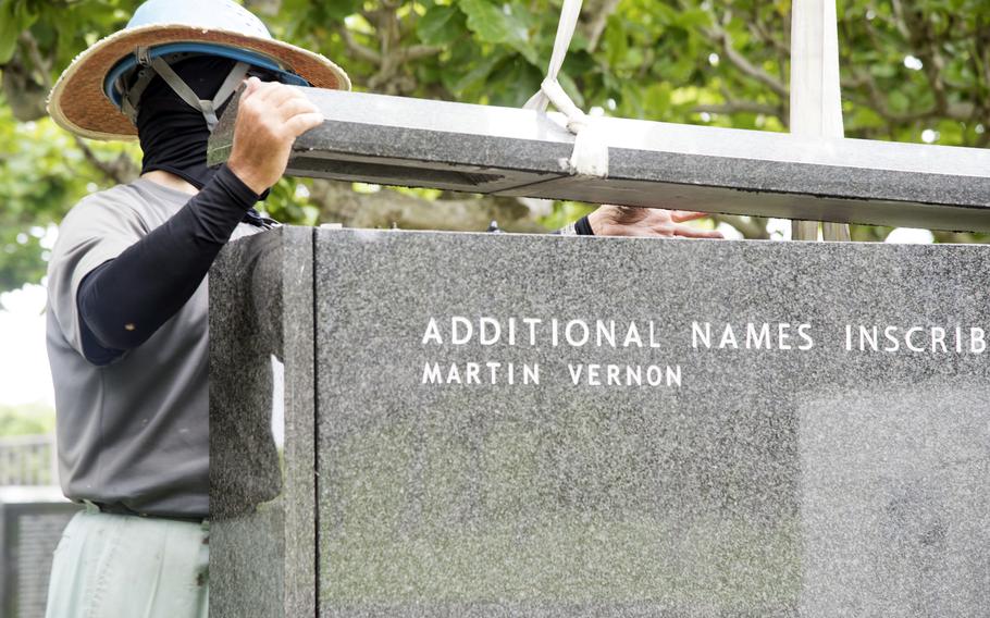 The name Martin Vernon is added to a stone monument.