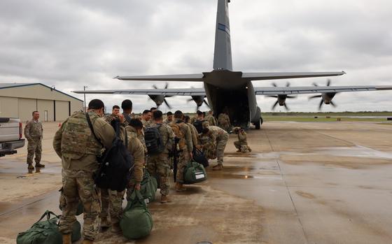 Service members from the Texas National Guard board aircraft in McAllen, Texas, to deploy to El Paso as part of a security response force. The mayor of El Paso on Saturday, Dec. 17, 2022, declared an emergency in the city because of an increase in migration from Mexico.