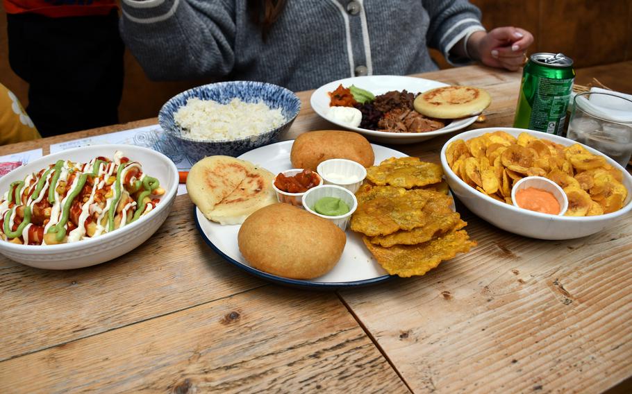 From left, mazorcada, abuela's rice, a starter platter, plantain chips and an arepa main course at La Latina Bustaurante in Cambridge, England. 